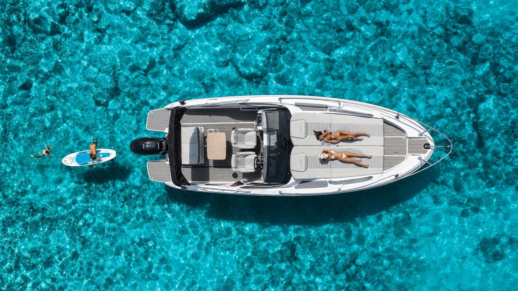 Drone view of the Chifbay boat at anchor in turquoise water off Madeira