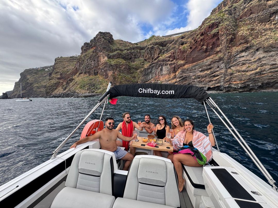 Guests on the Chifbay boat under the sea cliffs